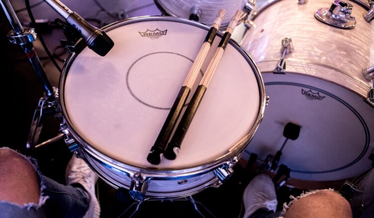 pair of drum stick on white snare drum